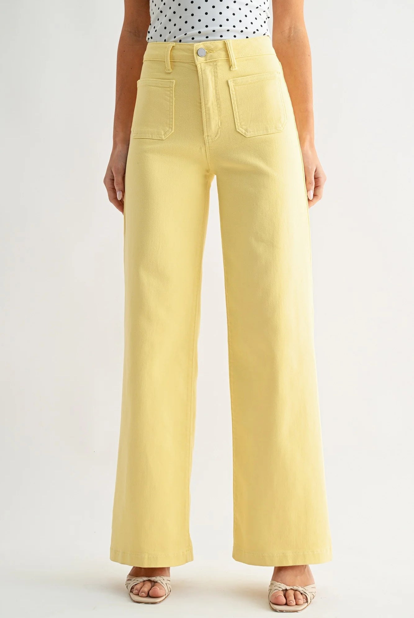 Yellow wide-leg pants worn by a person on a plain background