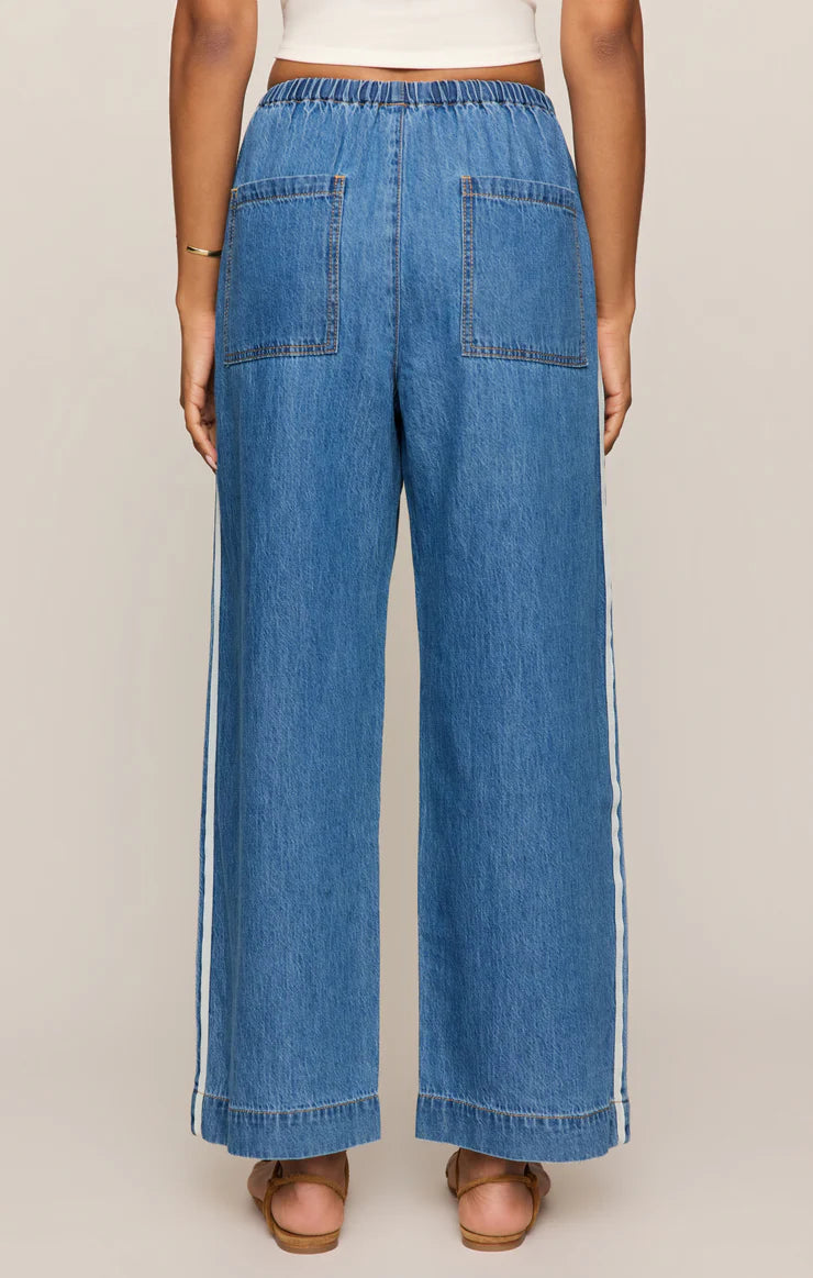 Blue denim wide-leg pants worn by a person on a plain background