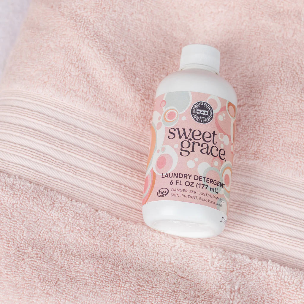Bottle of Sweet Grace laundry detergent on a pink towel