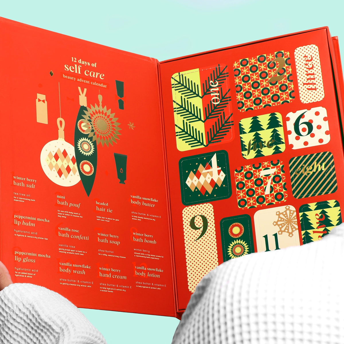Open advent calendar with colorful designs and numbers on a red background