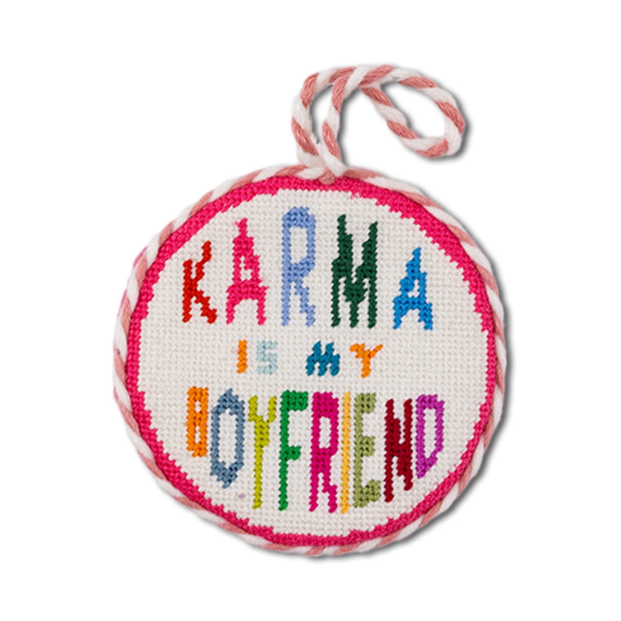 Round embroidered item with 'Karma is my boyfriend' text on a white background