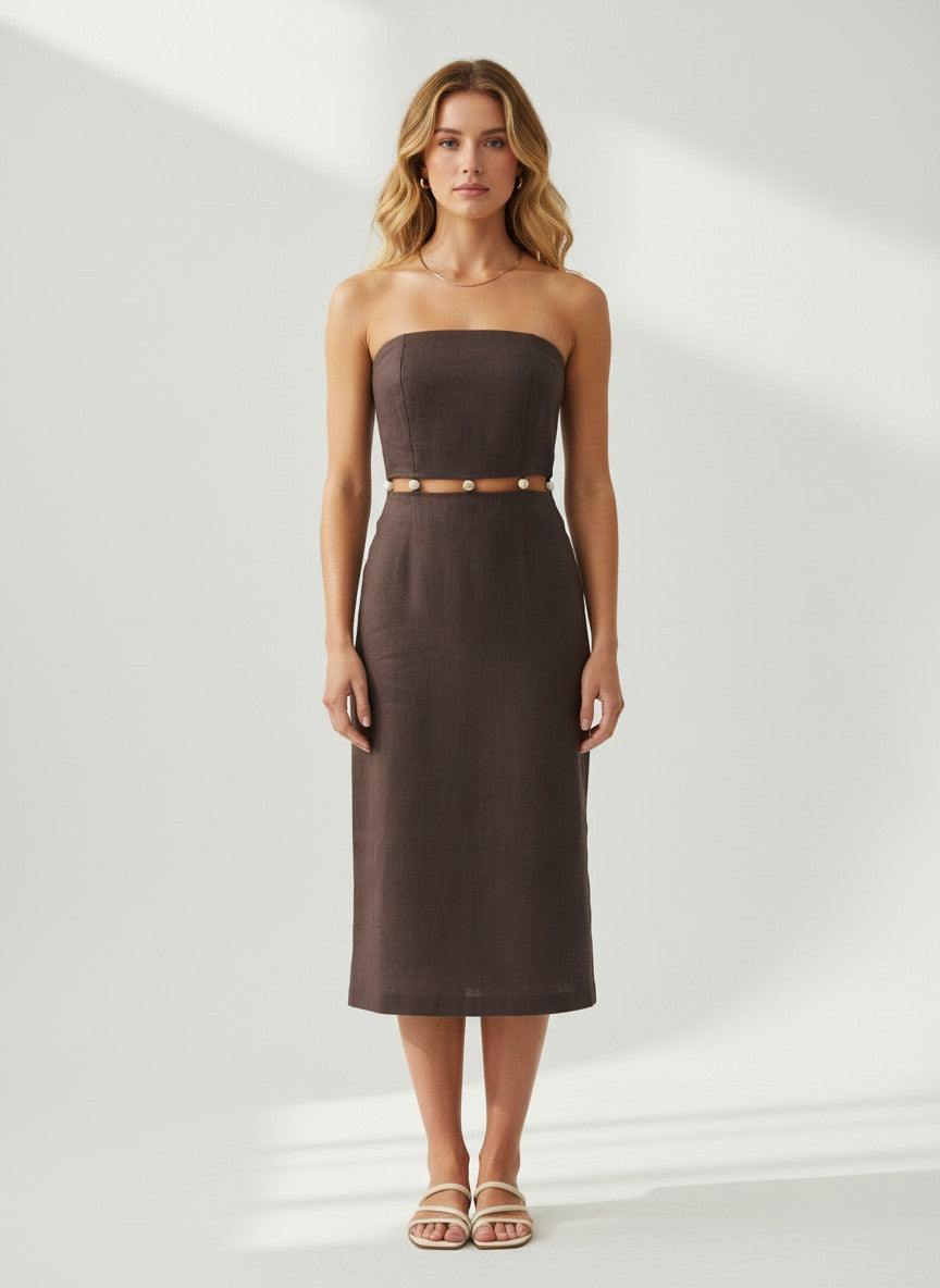 Woman wearing a strapless brown dress against a white background