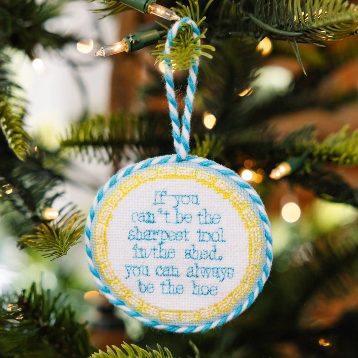 Decorative ornament with a quote on a Christmas tree