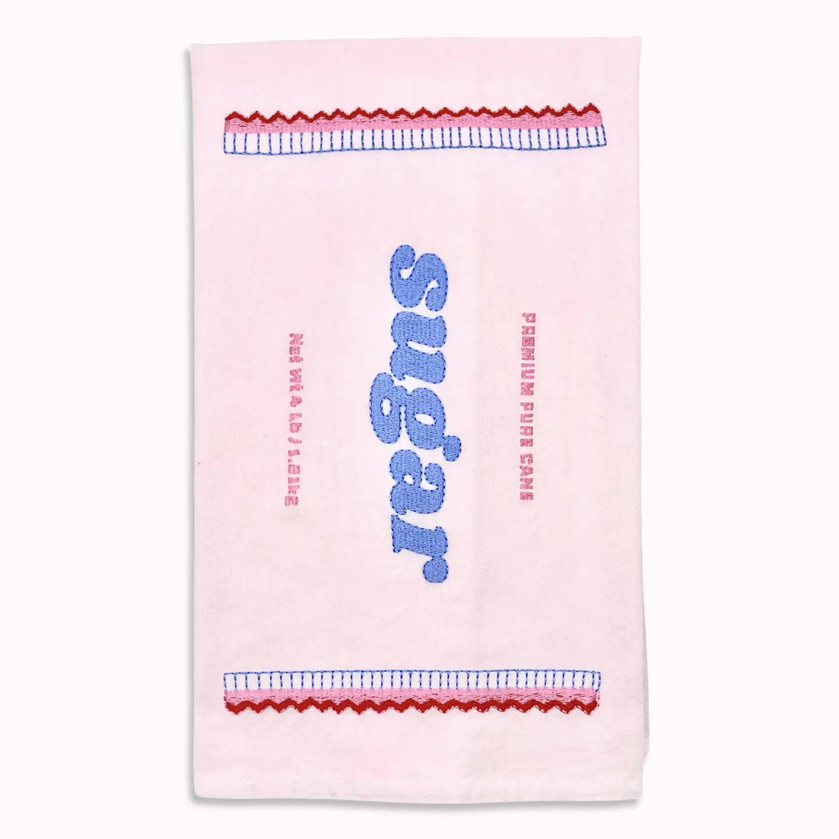 A light pink tea towel featuring a retro sugar-themed design with blue and red embroidered details.