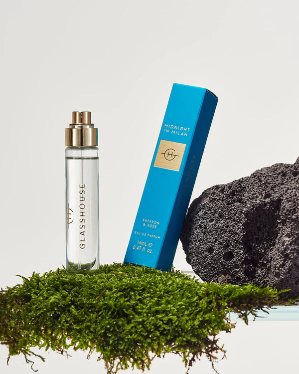 Glasshouse perfume bottle and packaging on a natural background with moss and stone.