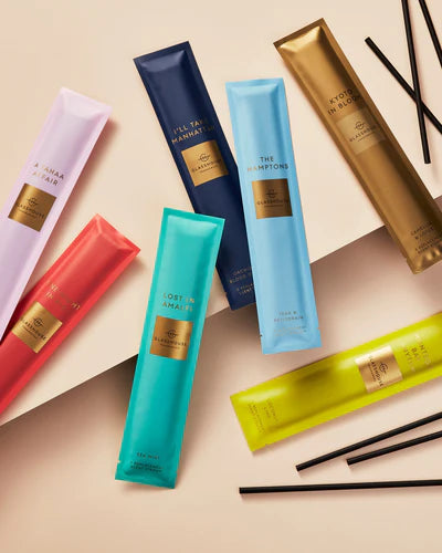 Colorful skincare product tubes with visible brand name on a beige background