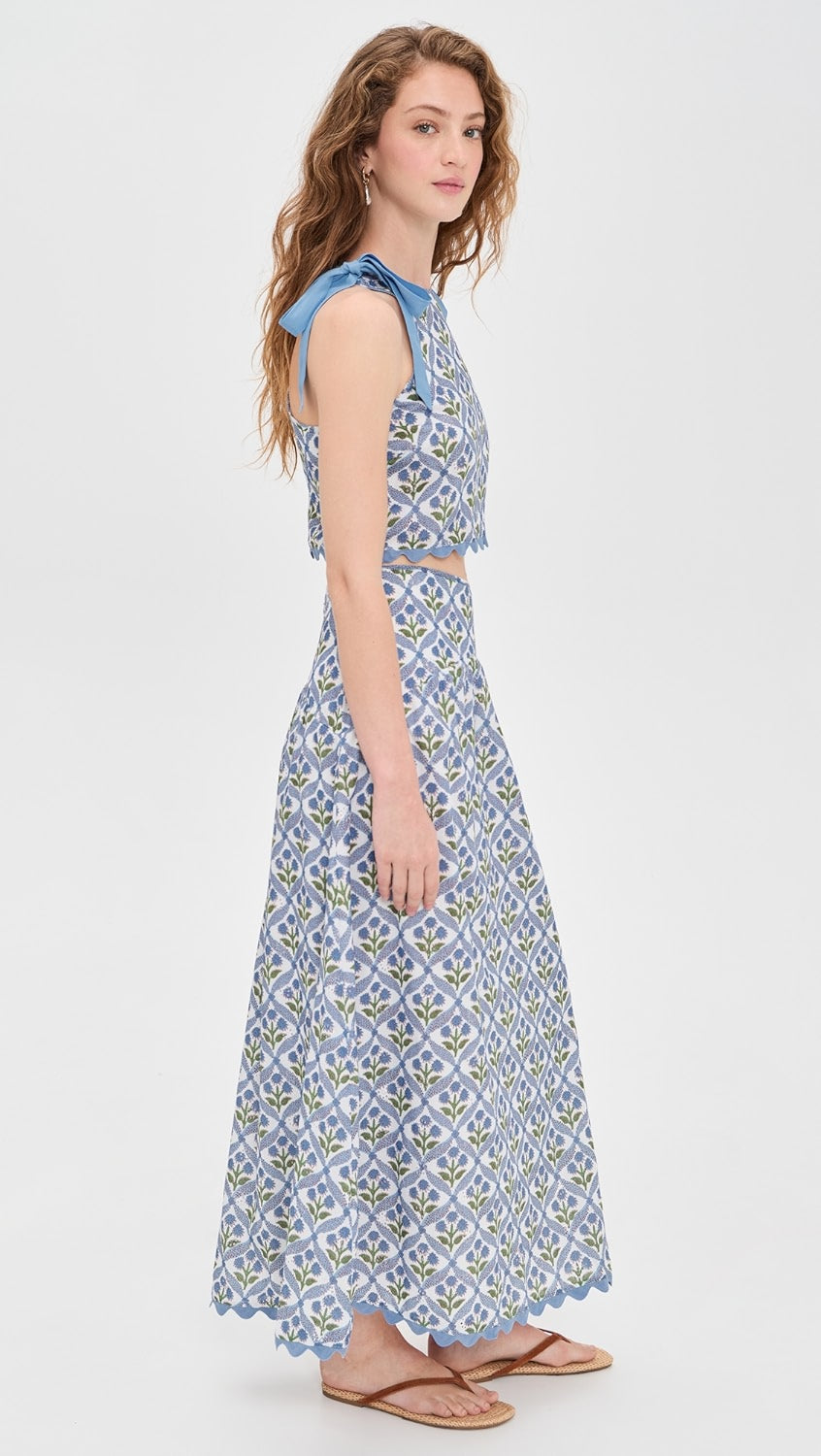 Woman wearing a blue patterned dress on a white background