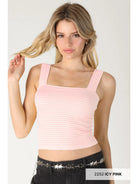 A blonde model wearing a light pink ribbed crop top with a square neckline and wide straps, paired with black jeans featuring a silver star belt. A text label in the bottom right corner reads '2252 ICY PINK'.