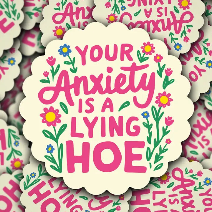 Sticker with 'Your Anxiety is a Lying Hoe' text surrounded by flowers on a patterned background.