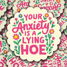 Sticker with 'Your Anxiety is a Lying Hoe' text surrounded by flowers on a patterned background.