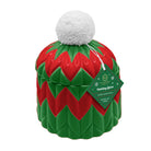 A ceramic Christmas elf hat scented candle by The Scent Company. The candle features a red and green chevron pattern with a white faux-fur pom-pom on top.