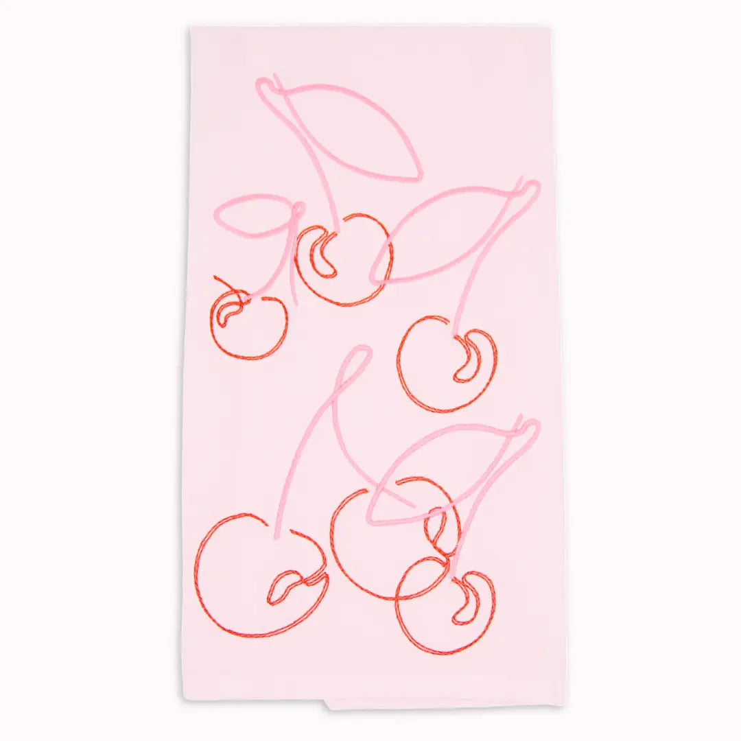 A light pink kitchen towel featuring a minimalist line-art pattern of cherries in shades of pink and red, shown flat against a white background.