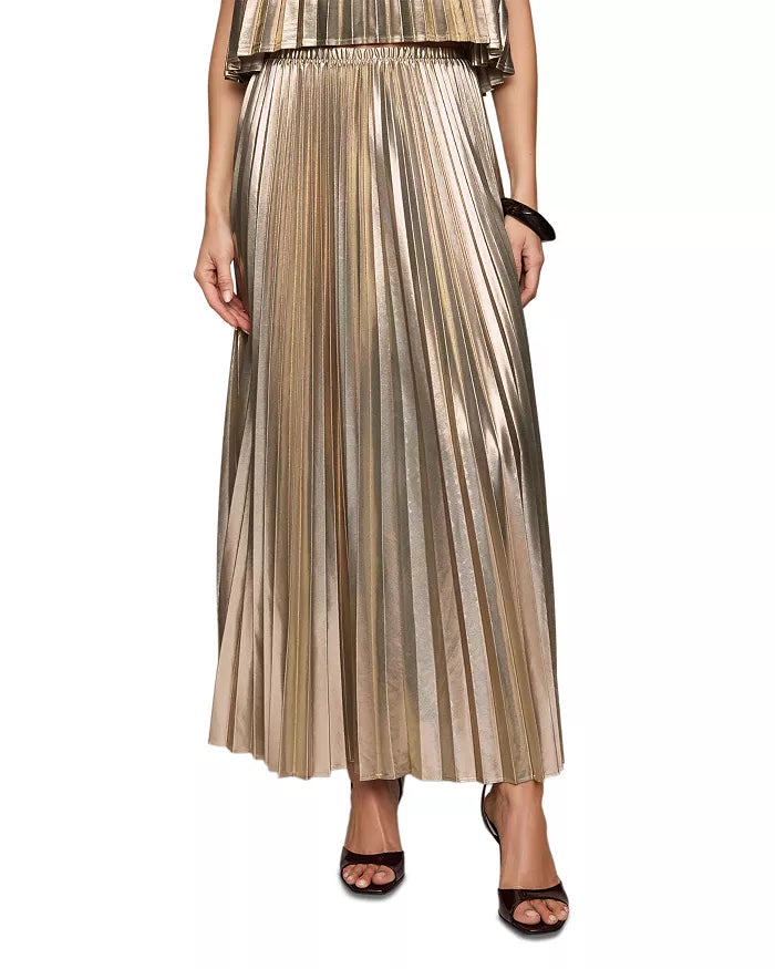 A model wearing a metallic gold pleated maxi skirt with a matching top, styled with black strappy heels against a plain white background.