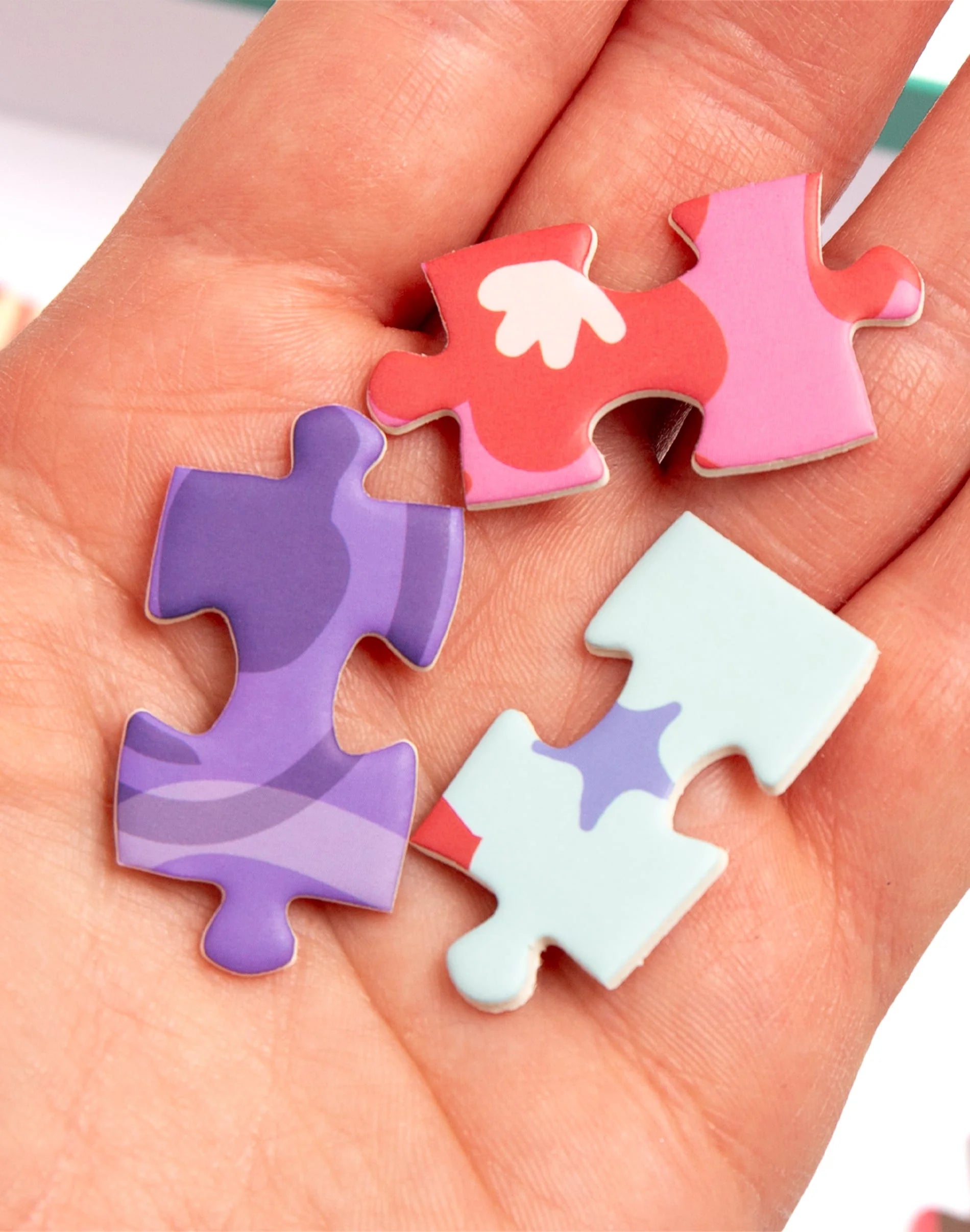 Colorful puzzle pieces held in a hand
