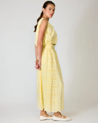 Woman wearing a yellow set with a white background