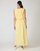 Woman wearing a yellow matching set with a white background