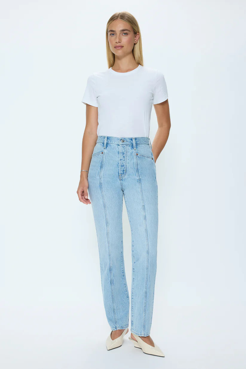 Woman wearing a white t-shirt and light blue jeans on a white background
