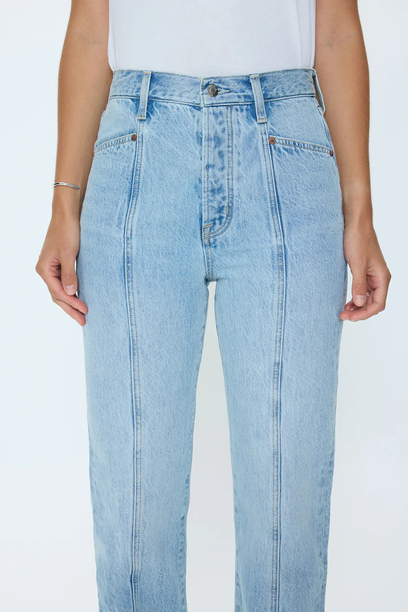 Light blue jeans worn by a person on a white background