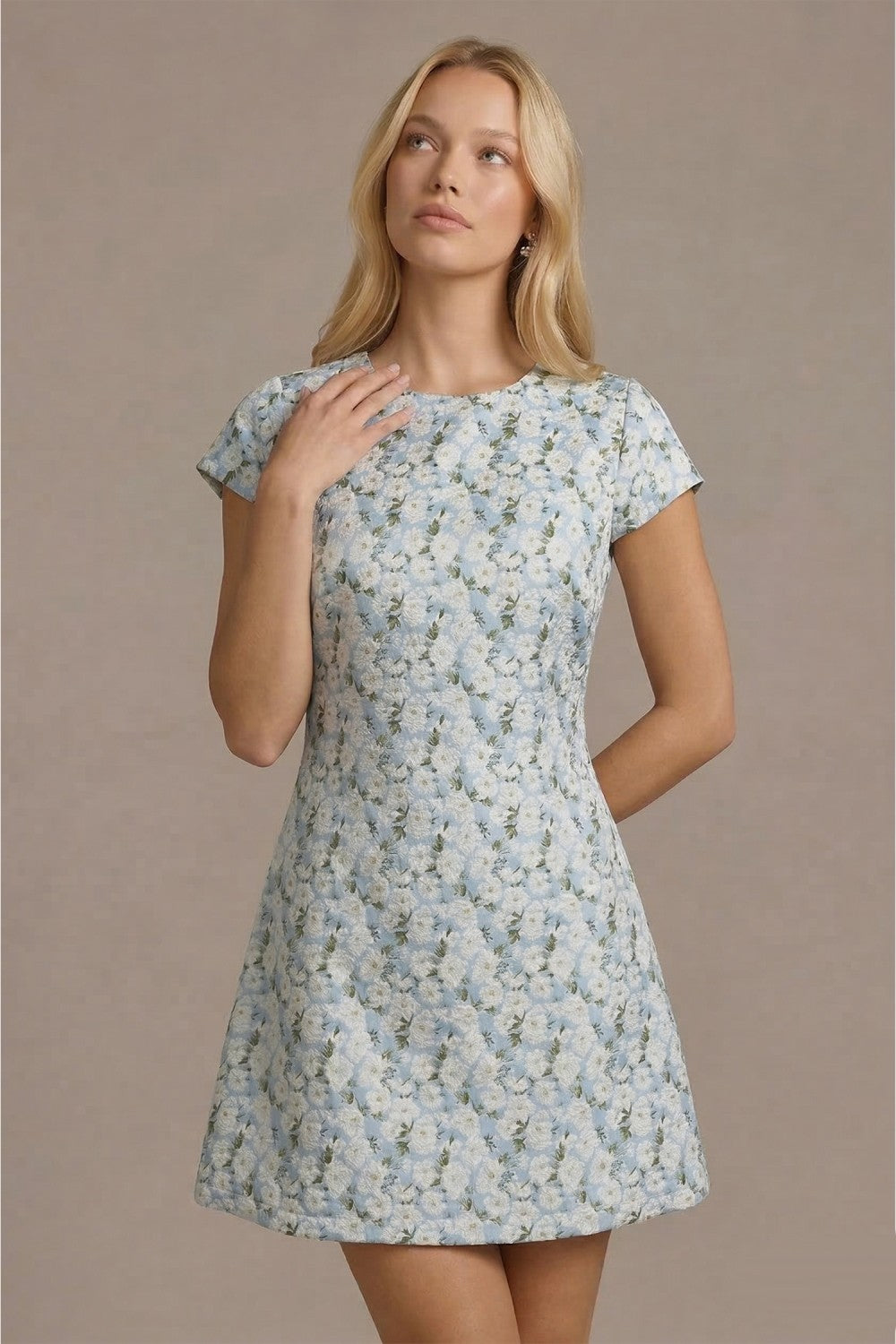 Woman wearing a floral dress against a beige background