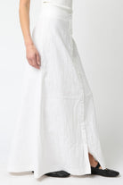 White dress with a slit on a white background