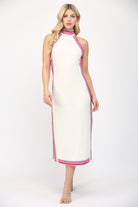Woman wearing a white dress with pink trim on a white background