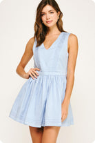 Woman wearing a light blue dress on a white background