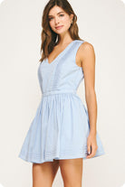 Woman wearing a light blue dress on a white background