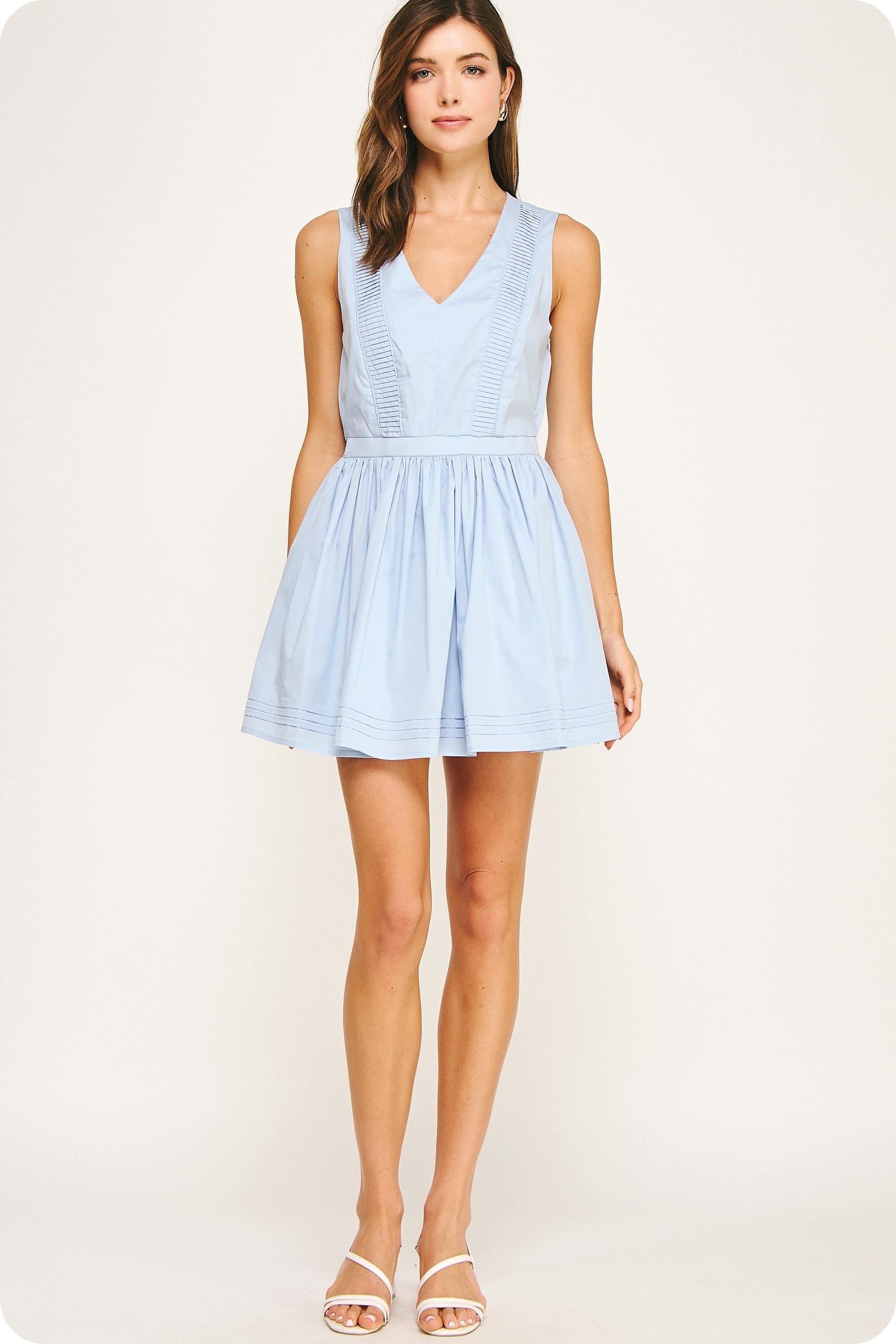 Woman wearing a light blue dress on a white background