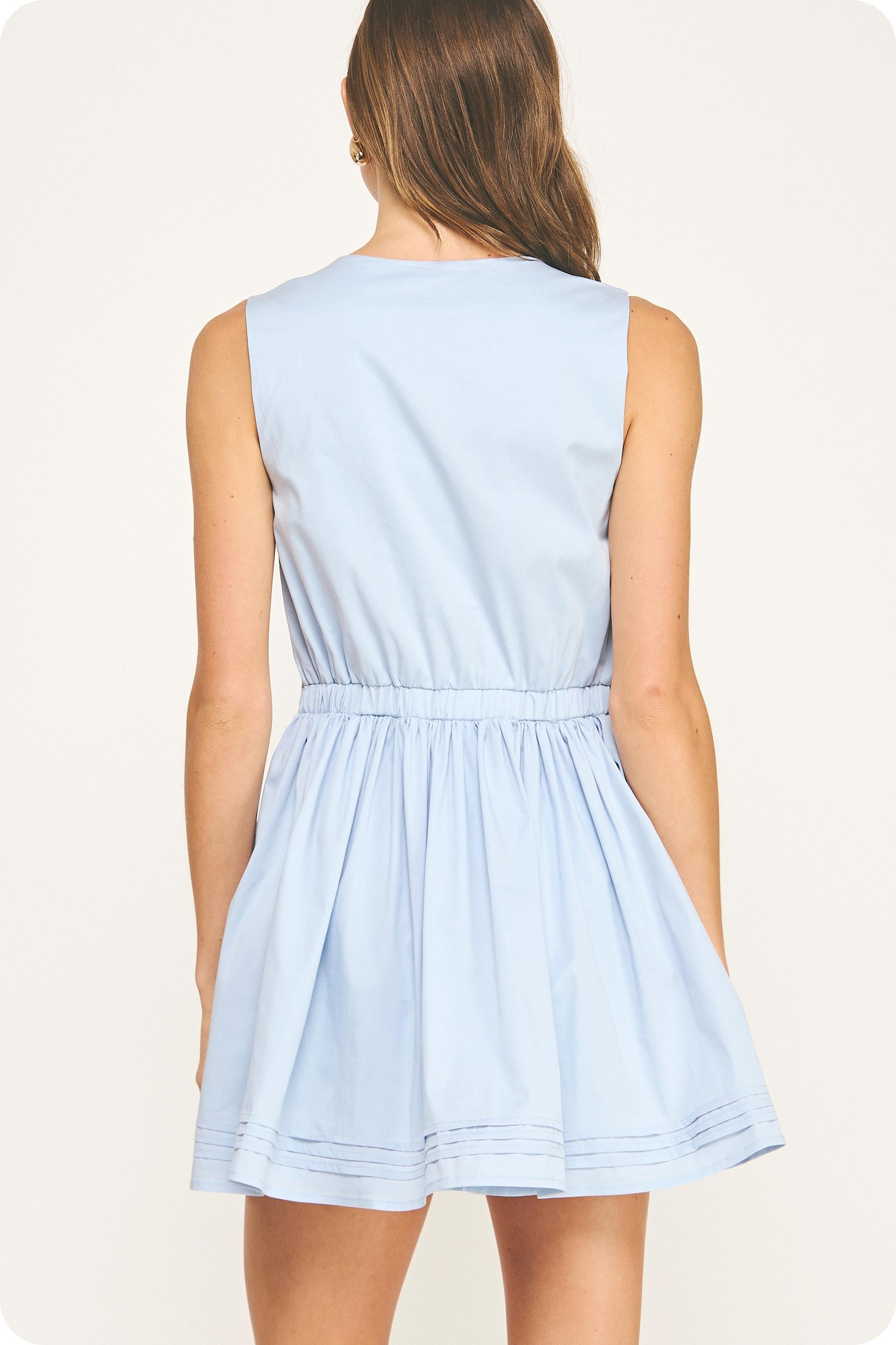 Light blue sleeveless dress worn by a model on a white background