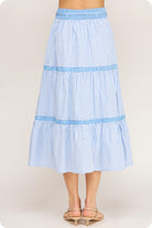 Light blue striped skirt worn by a person on a plain background