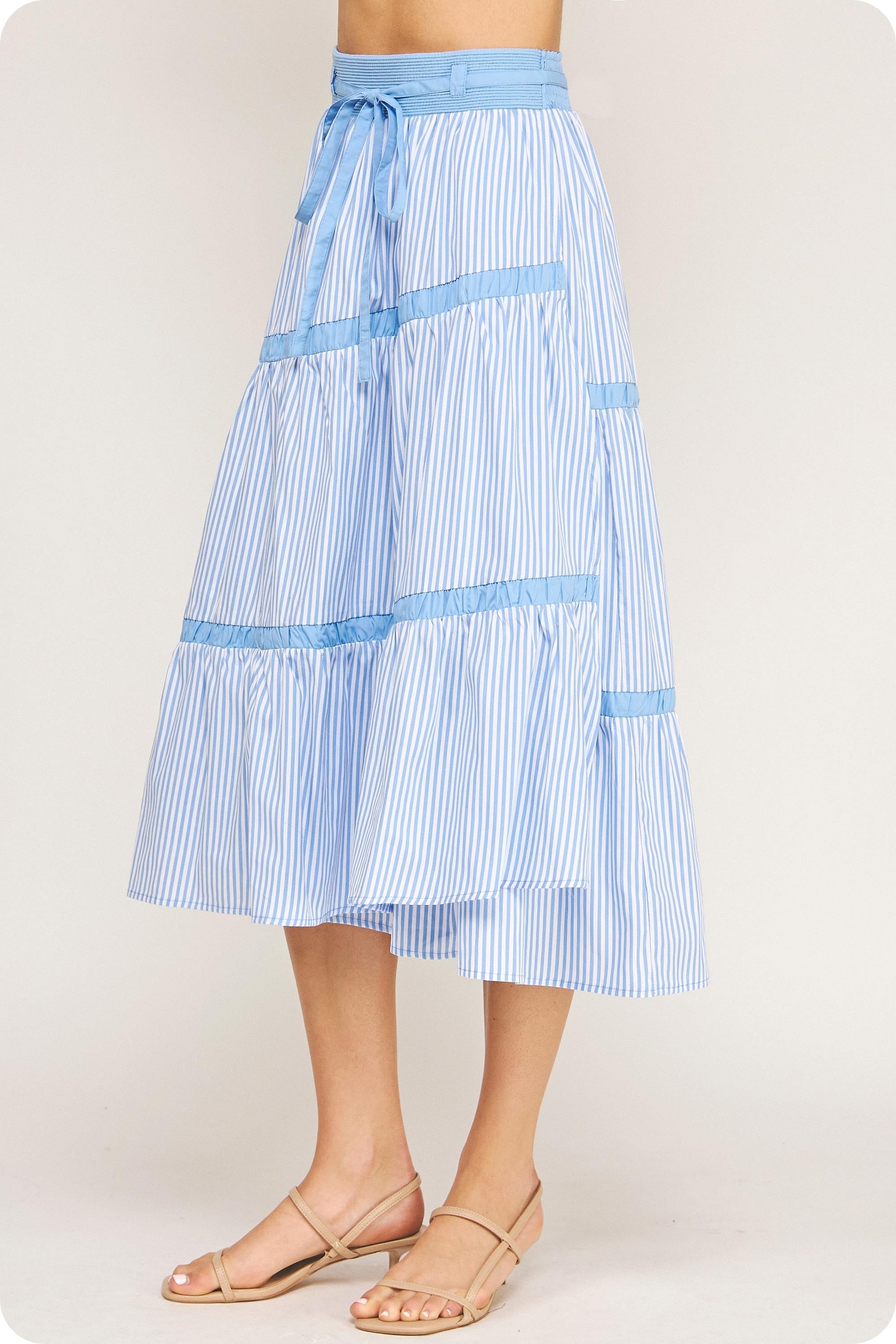 Blue and white striped skirt on a plain background