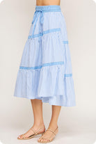 Blue and white striped skirt on a plain background