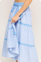 Blue and white striped skirt with a tie waist on a plain background