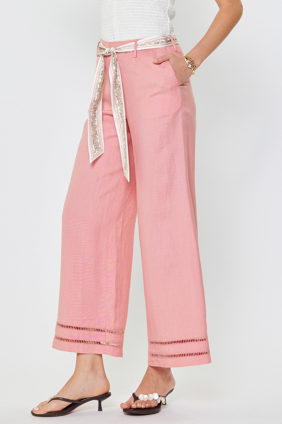Pink pants with a decorative belt on a white background
