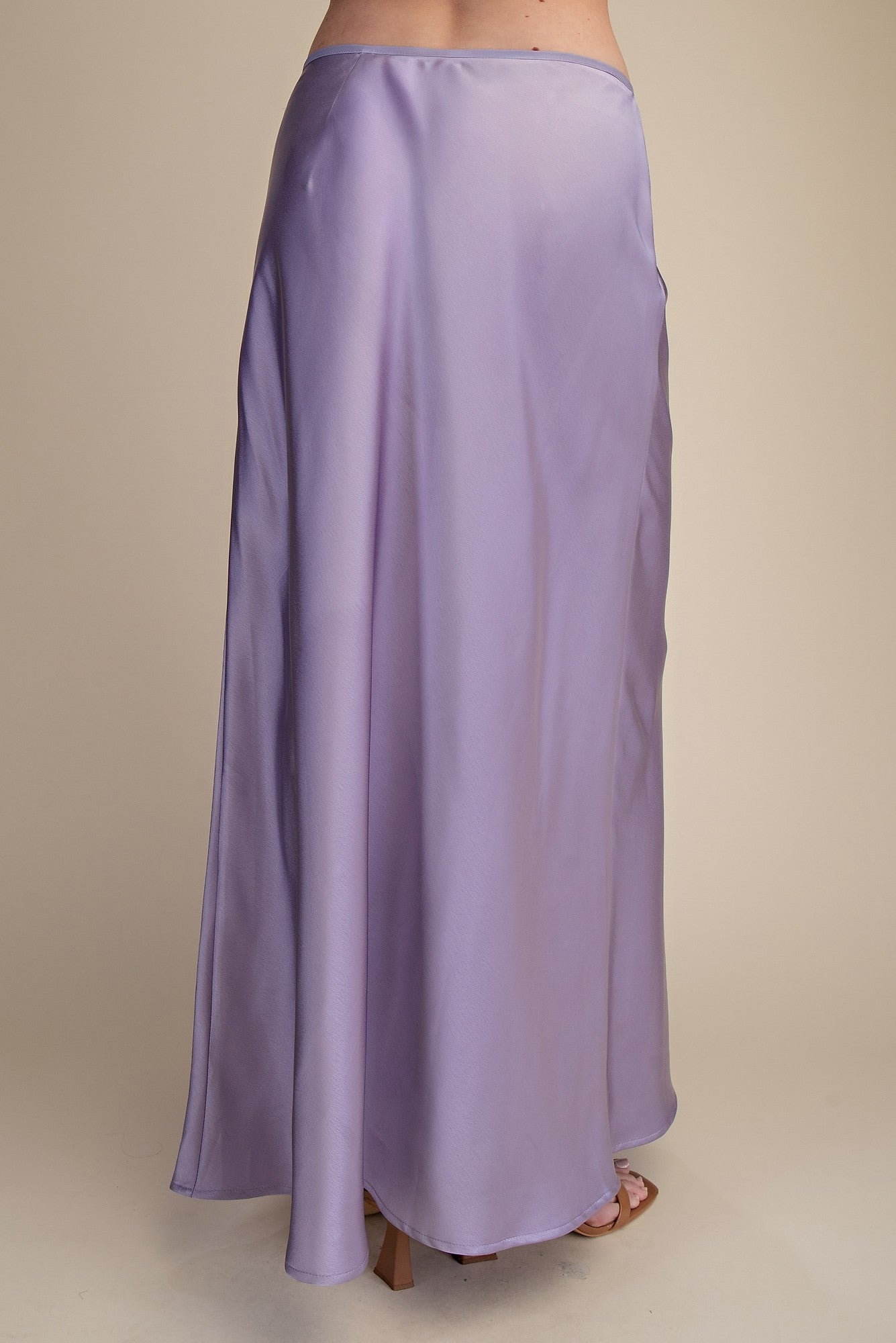 Purple satin skirt on a beige background