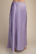 Purple satin skirt on a beige background