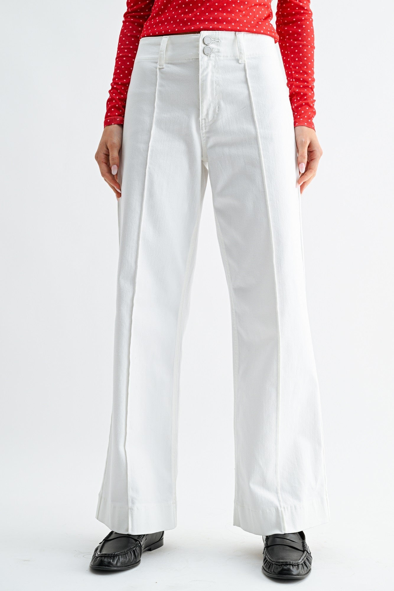 White pants worn by a person on a white background