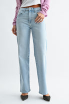 Light blue jeans worn by a person on a white background