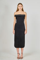 Black strapless dress with a bow detail on a white background