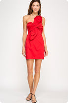 Red strapless dress with a bow detail on a white background