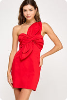 Woman wearing a red one-shoulder dress on a white background