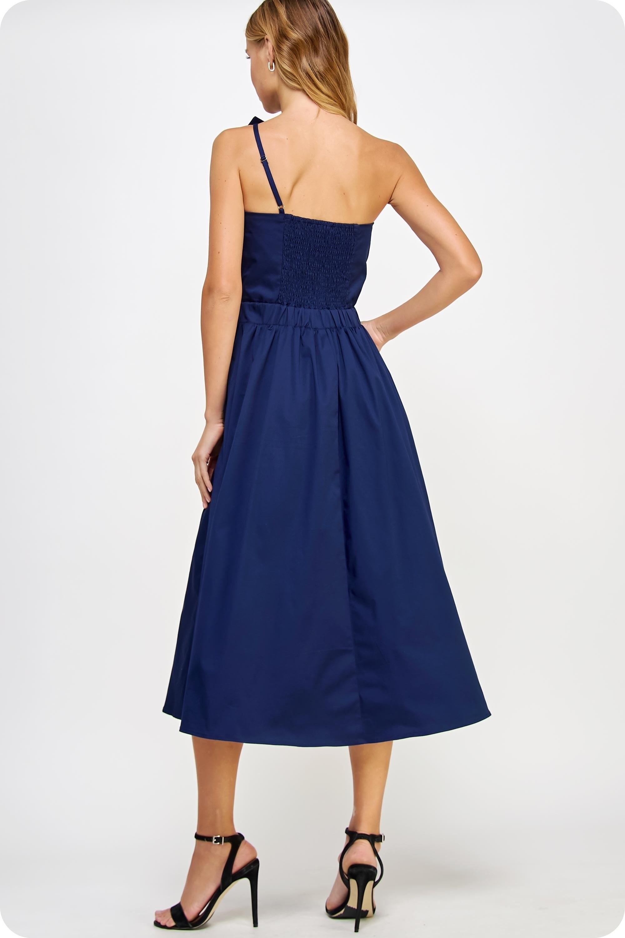 Woman wearing a navy blue dress on a white background