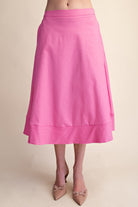 Pink skirt worn by a person on a beige background