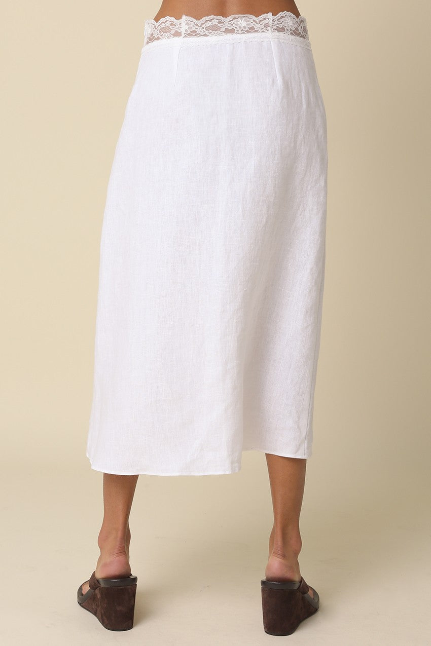 White skirt with lace waistband on a beige background