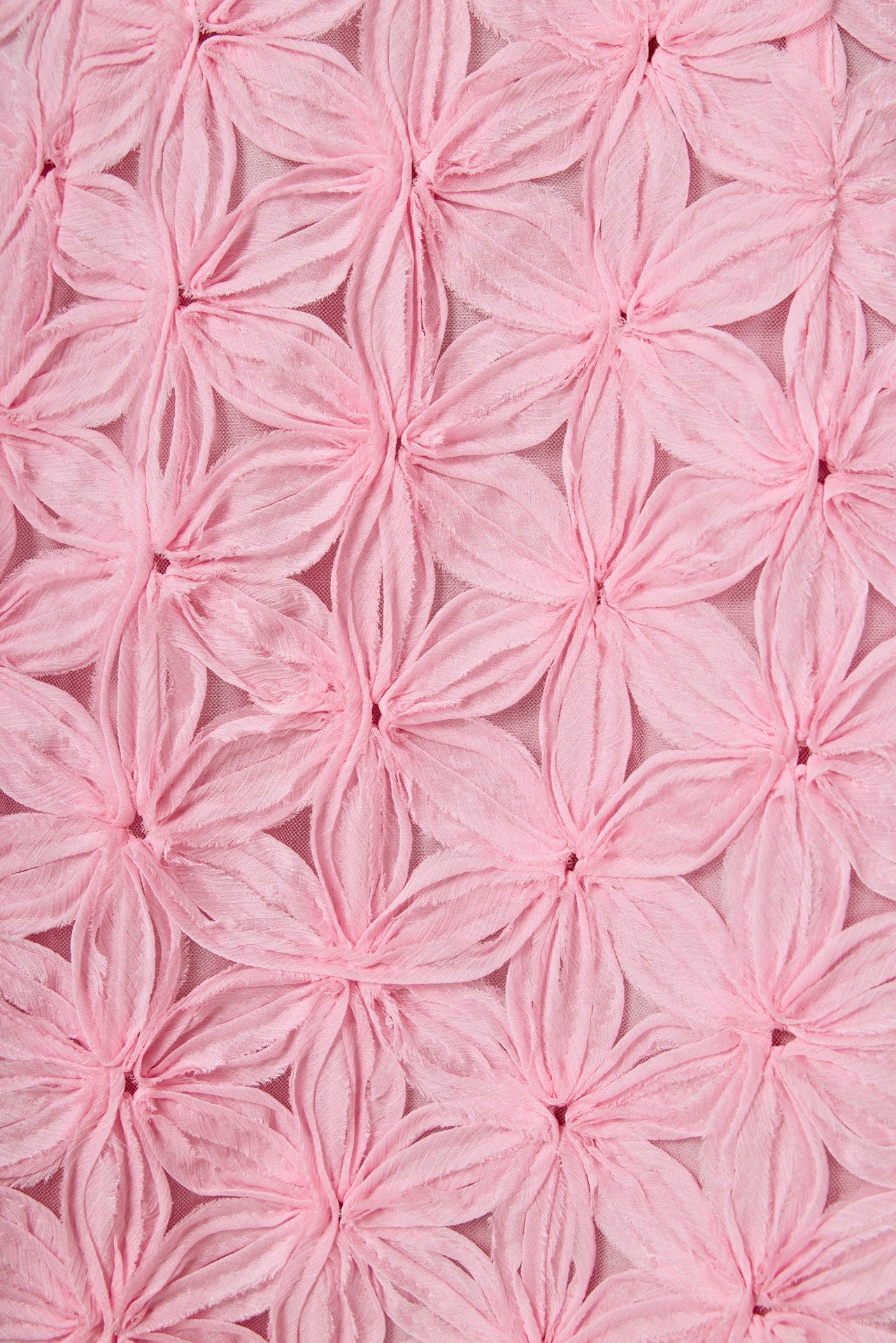 Close-up of pink textured fabric with floral patterns