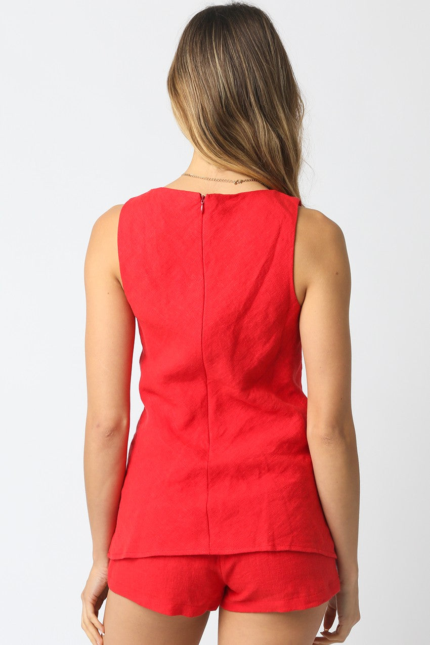 Red sleeveless top and shorts set on a plain background