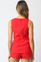 Red sleeveless top and shorts set on a plain background