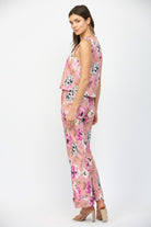 Woman wearing a pink floral outfit on a white background