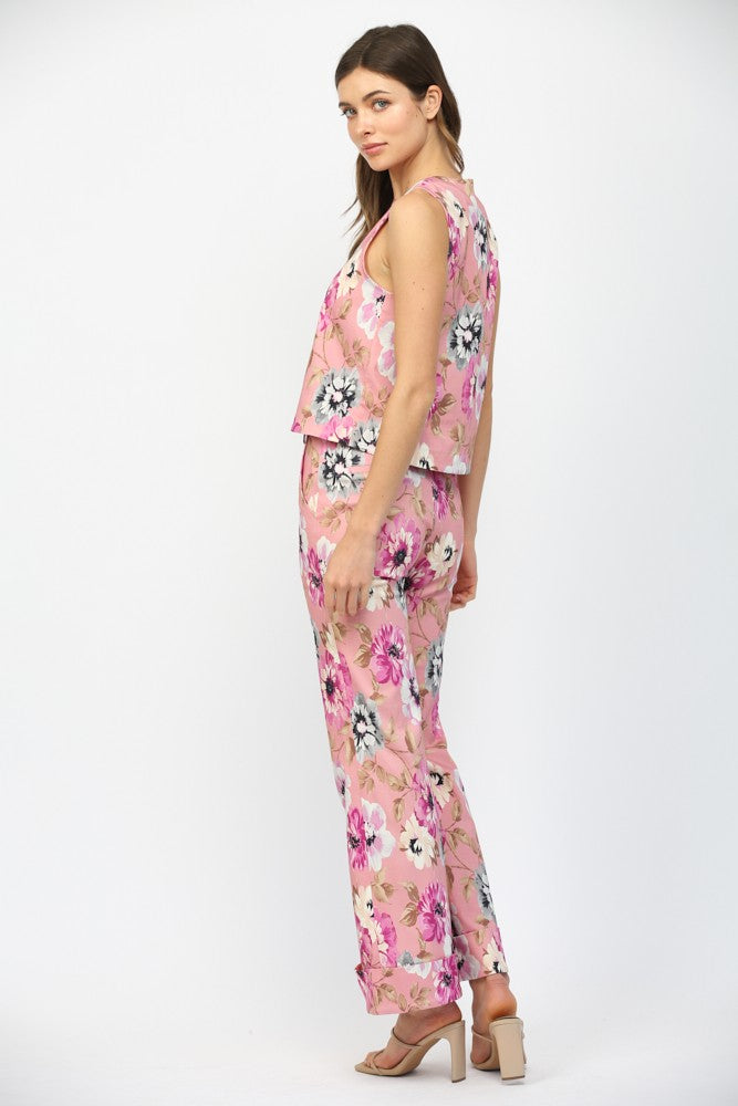 Woman wearing a pink floral outfit on a white background