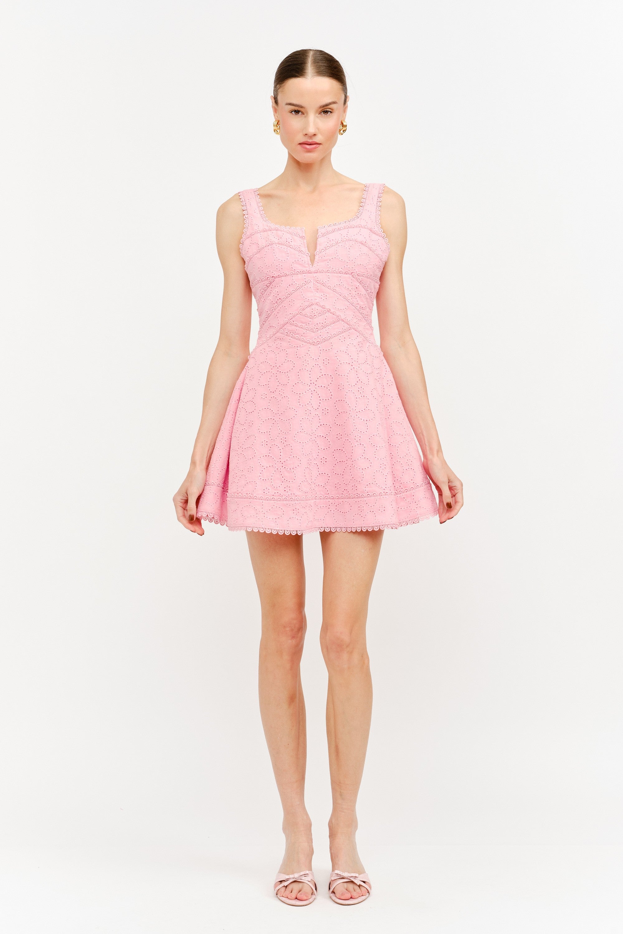 Woman wearing a pink dress on a white background
